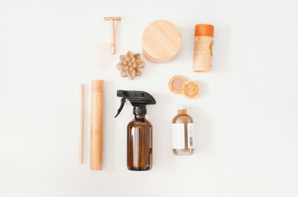 A zero-waste concept. Safety razor, bamboo rounds, zero-waste deodorant, bamboo toothbrush, apple cider vinegar spray, natural makeup remover, mineral eye-shadow, bar soap shampoo.